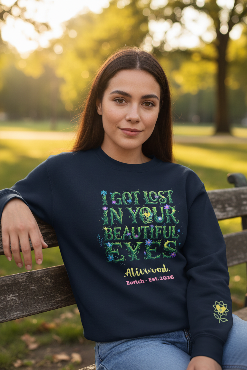 Woman wearing a navy blue sweatshirt with colorful text in a park