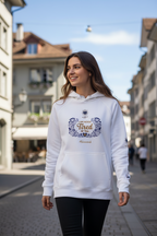 Woman wearing a white hoodie with a design on a street