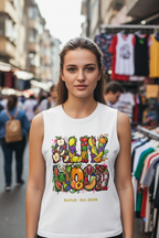 Woman wearing a white sleeveless shirt with colorful text and fruit design in an outdoor market setting.