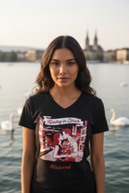 Woman wearing a black t-shirt with a graphic design by a lake with swans